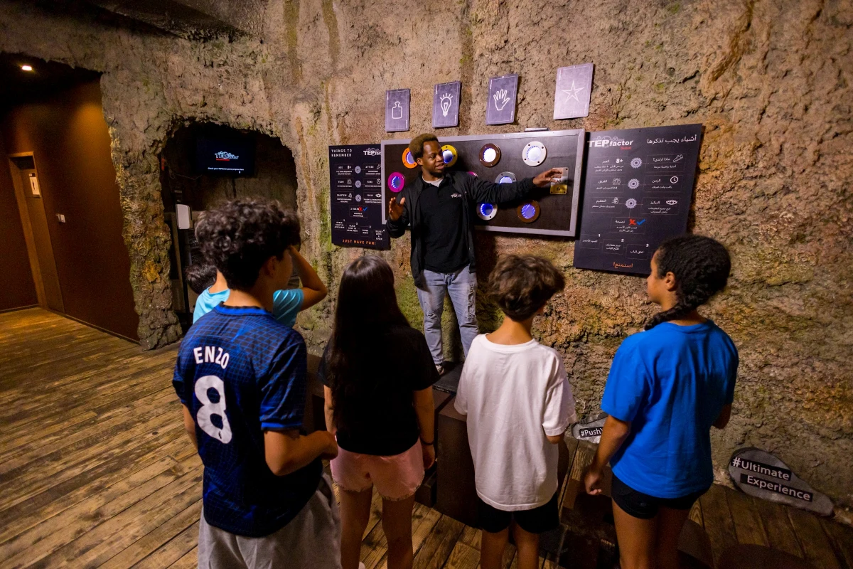 Students listening to a TEPfactor game host explain the next challenge